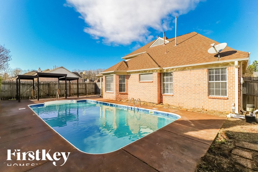 A house with a pool in the backyard.