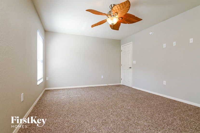 the master bedroom is spacious and has a ceiling fan