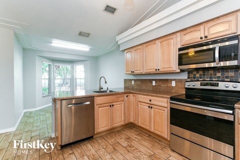 A kitchen with wooden cabinets and stainless steel appliances.