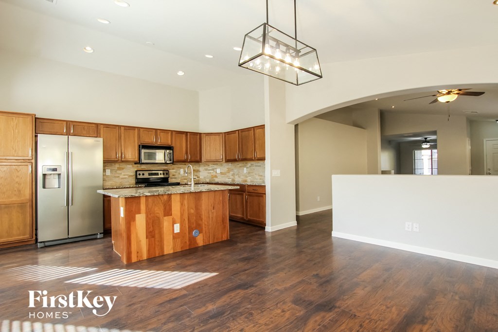 A kitchen with wooden cabinets and a granite countertop.
