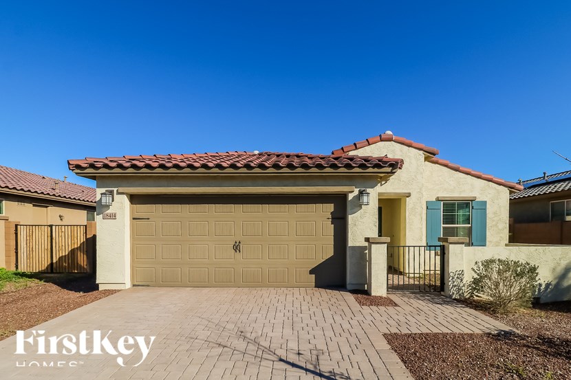A house with a brown tiled roof and a garage door.