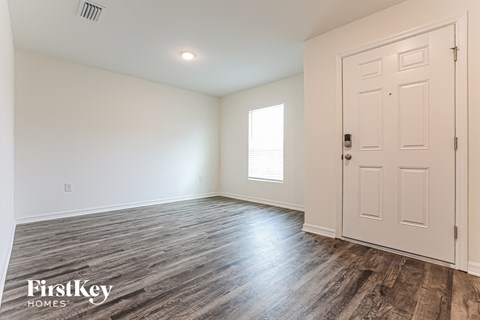 a bedroom with white walls and a white door
