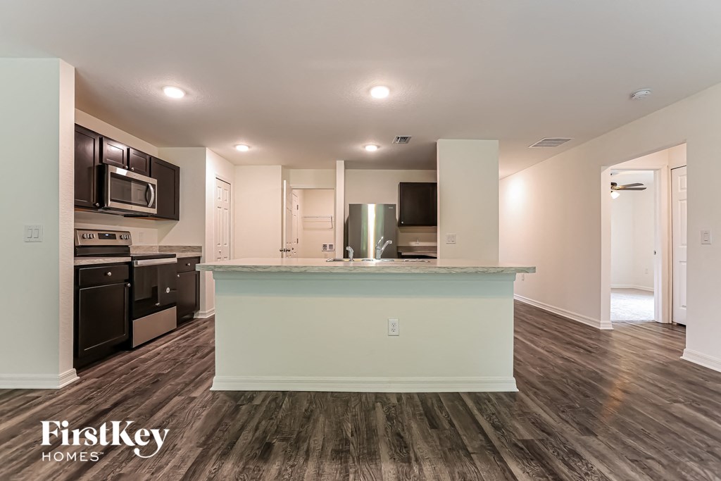 a renovated kitchen with a counter top in the middle