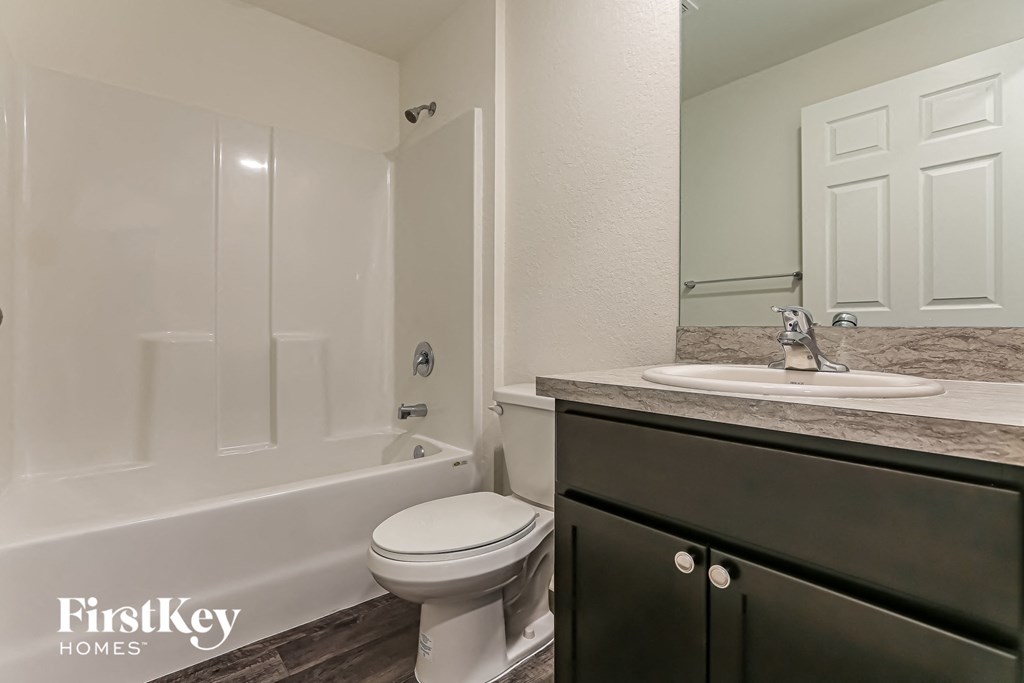 a bathroom with a sink toilet and bath tub