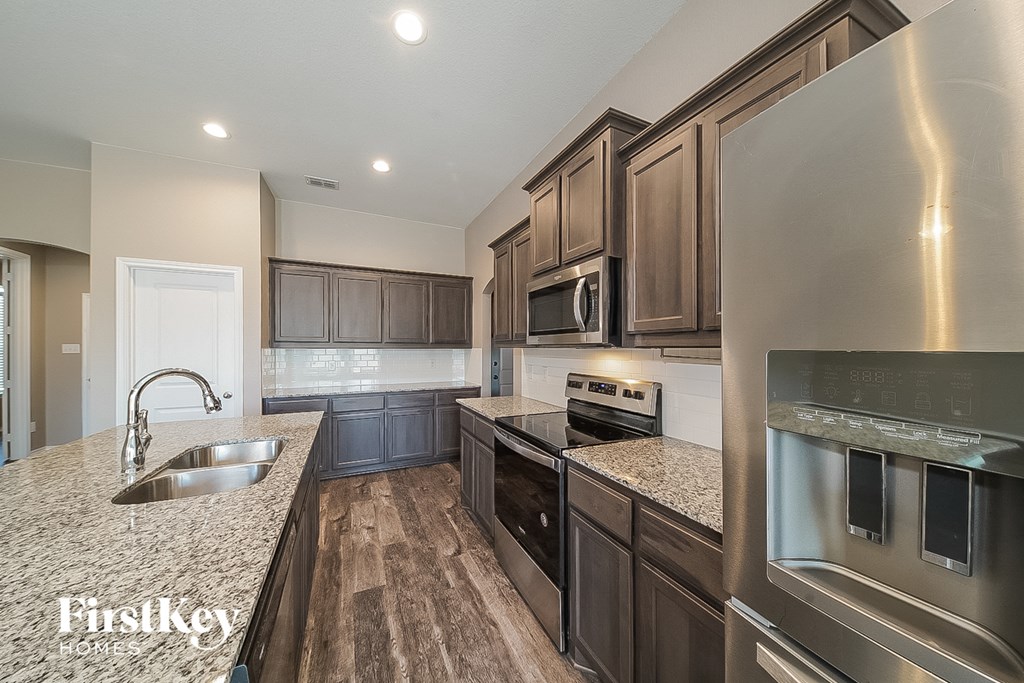 a kitchen with stainless steel appliances and granite counter tops