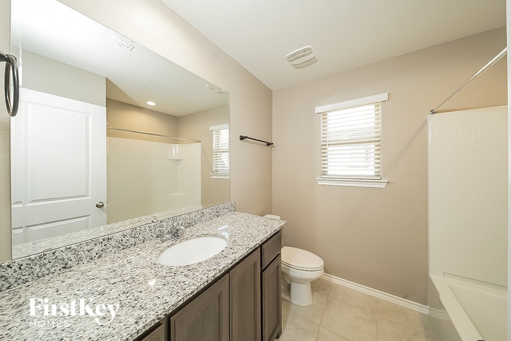 a bathroom with a sink and a toilet and a shower