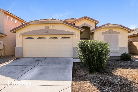 a home with a white garage door and a driveway