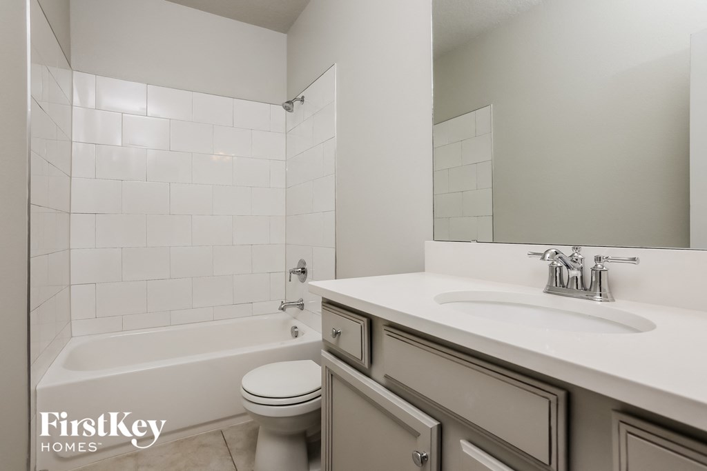 a bathroom with a sink and a toilet and a tub