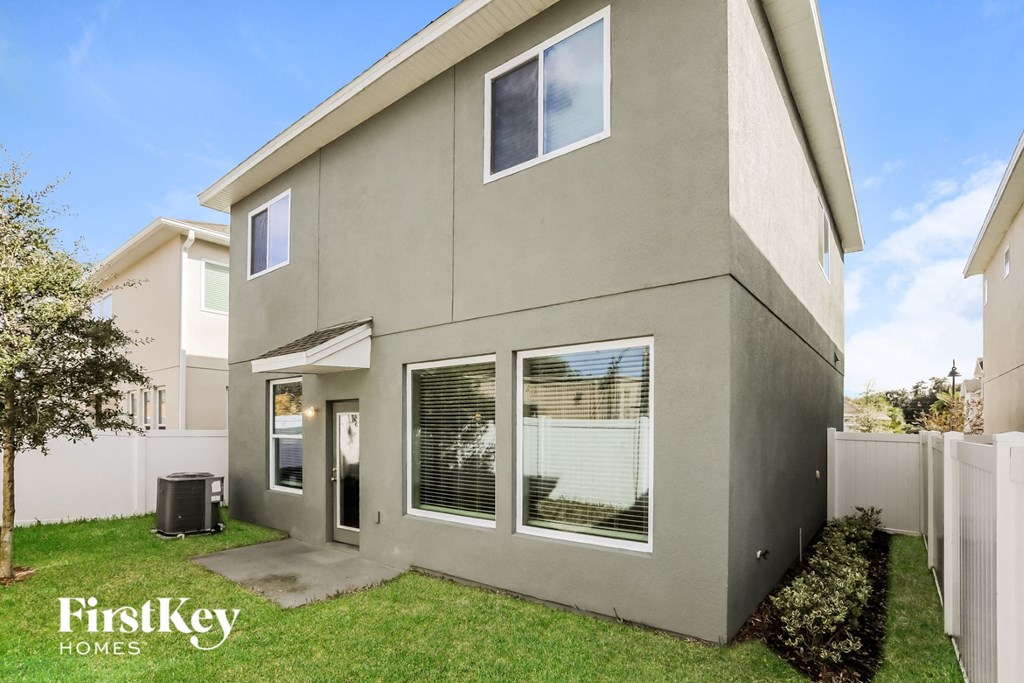the front of a house with grass and a yard