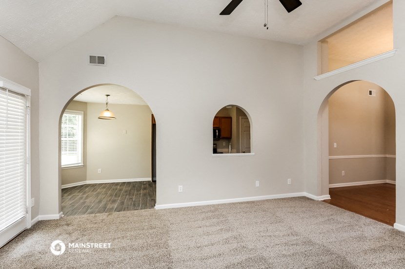 the living room and dining room with arched doorways