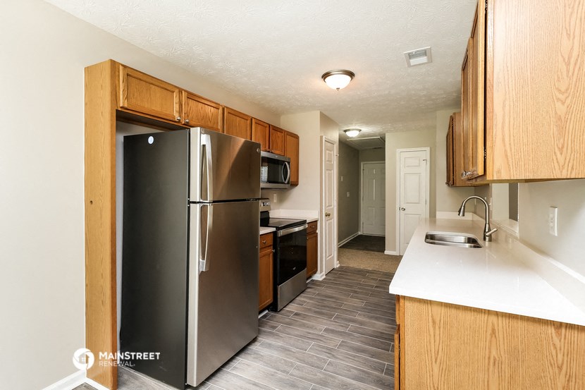a kitchen with stainless steel appliances and wooden cabinets