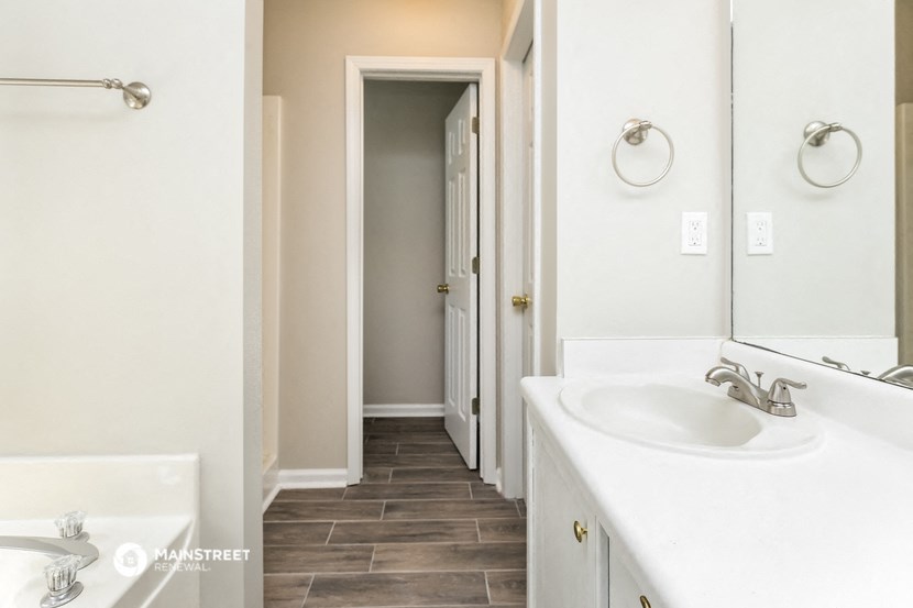 an empty bathroom with a sink and a mirror