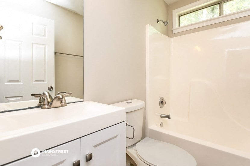 a bathroom with a sink and a toilet and a shower