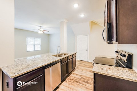 a kitchen with a counter top and a sink