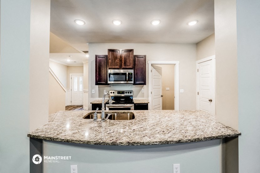 a kitchen with a granite counter top and a sink
