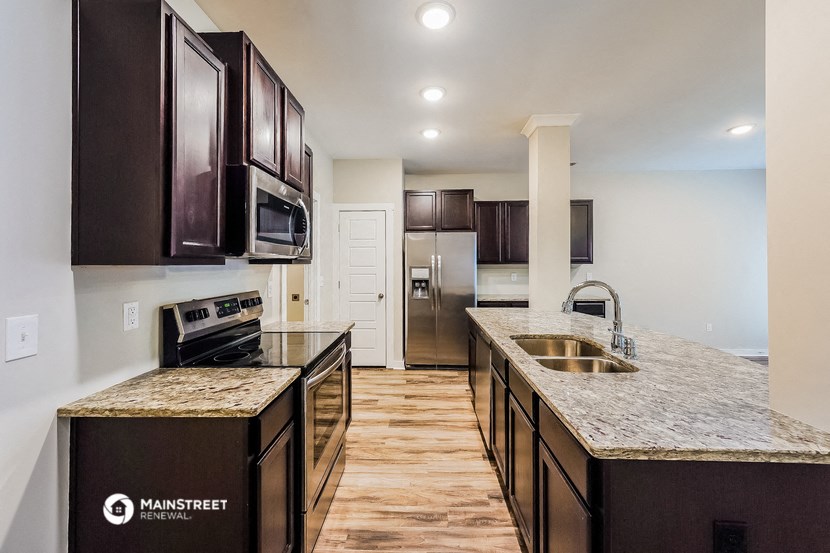 a kitchen with granite counter tops and a sink