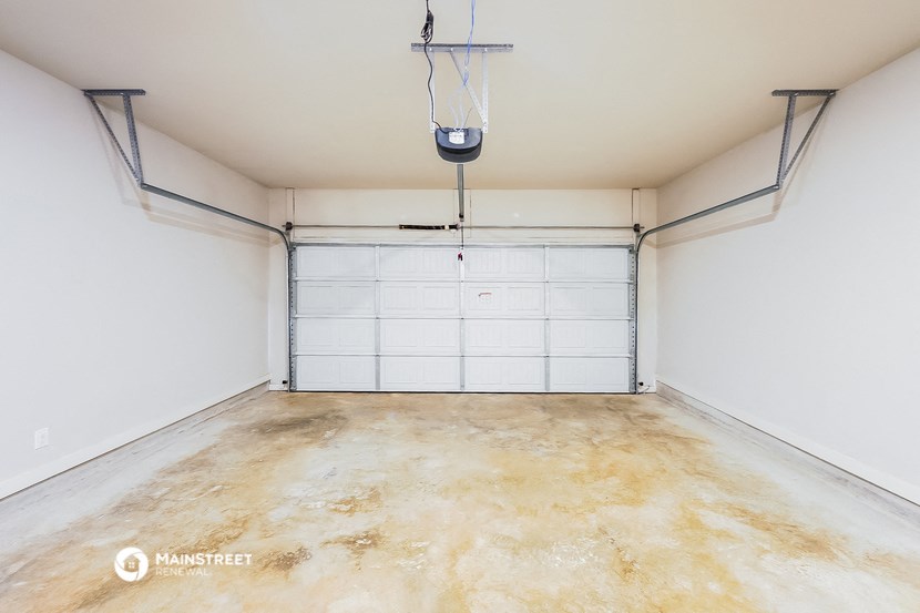 an empty garage with a white wall and a door