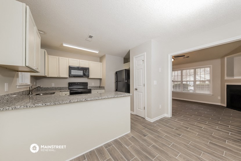 the spacious kitchen and living room of a manufactured home