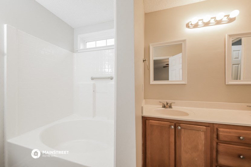 a bathroom with a shower and a sink and a mirror