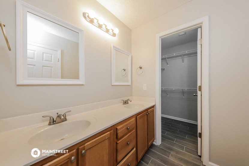 a bathroom with a sink and a mirror and a shower