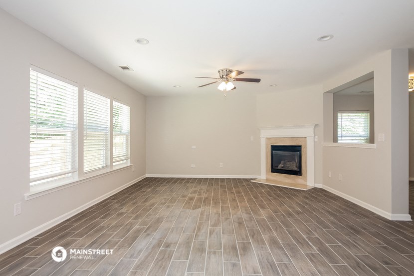 the living room of a new home with a fireplace