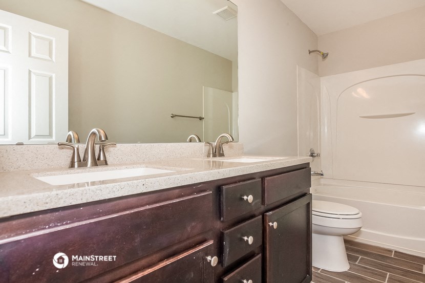 a bathroom with a sink and a toilet and a mirror