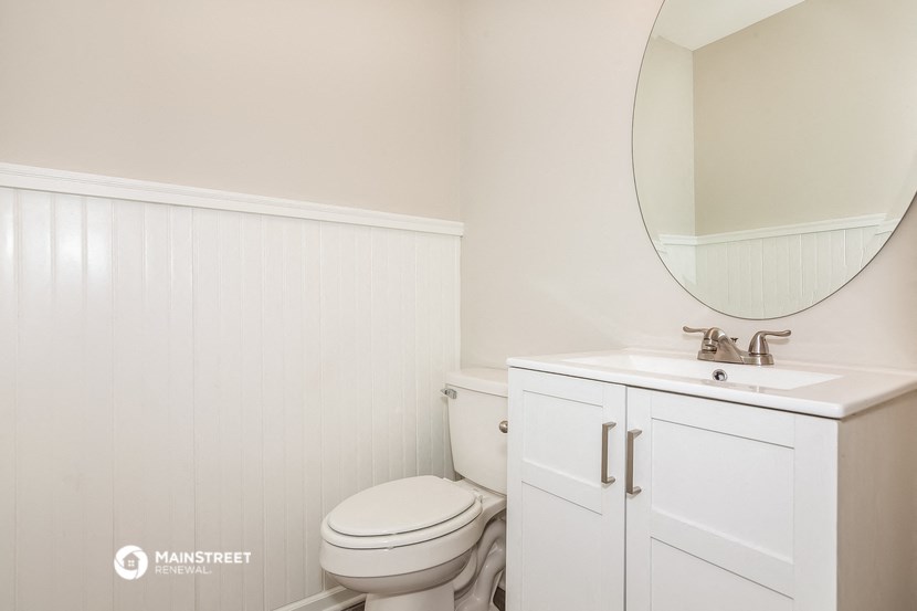 a white bathroom with a toilet and a sink