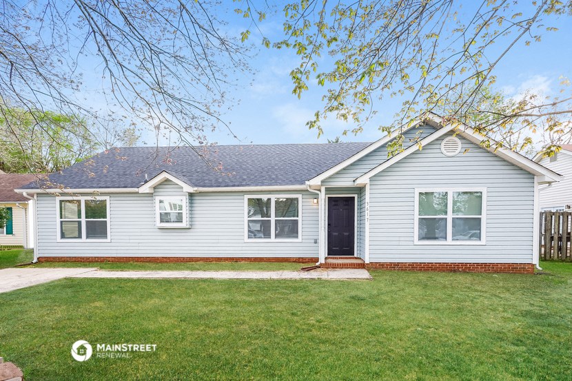 a white house with a yard in front of it