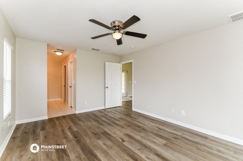 the living room of our studio apartment atrium with a ceiling fan