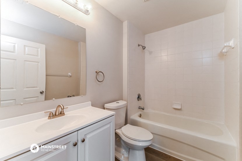 a bathroom with a sink toilet and a bath tub