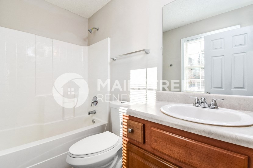a white bathroom with a sink toilet and tub