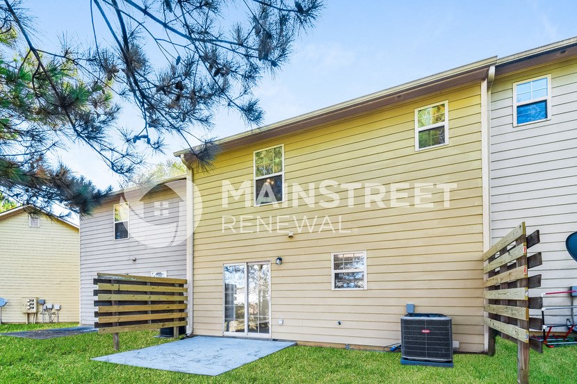 a side view of a house with a garage and a yard