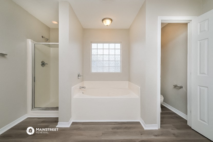 the master bathroom has a soaking tub and a walk in shower