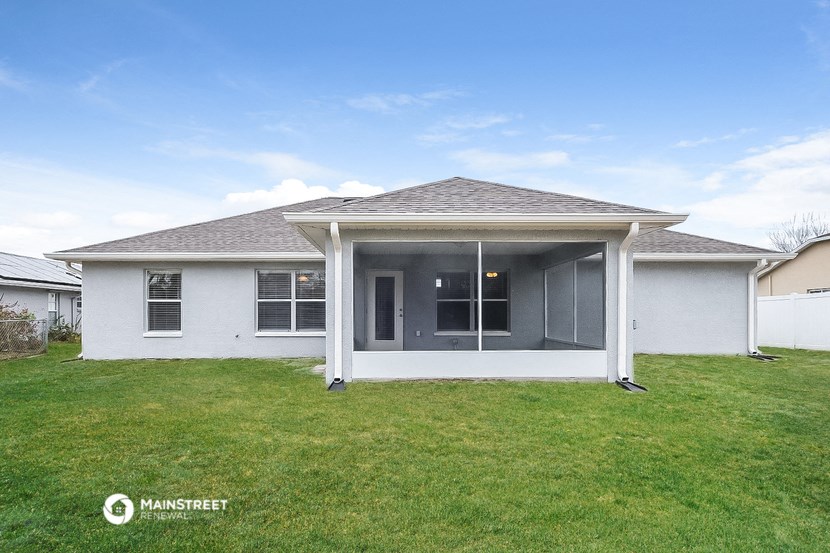a white house with a lawn and a porch