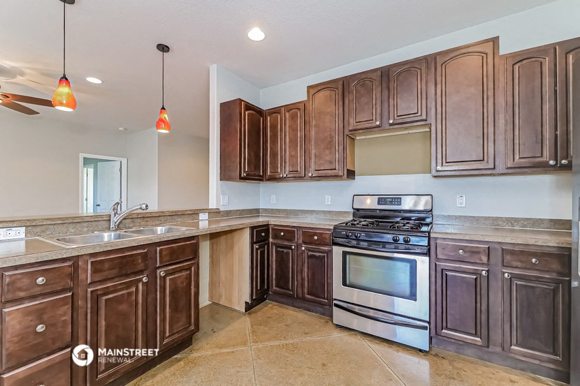 a kitchen with wooden cabinets and stainless steel appliances