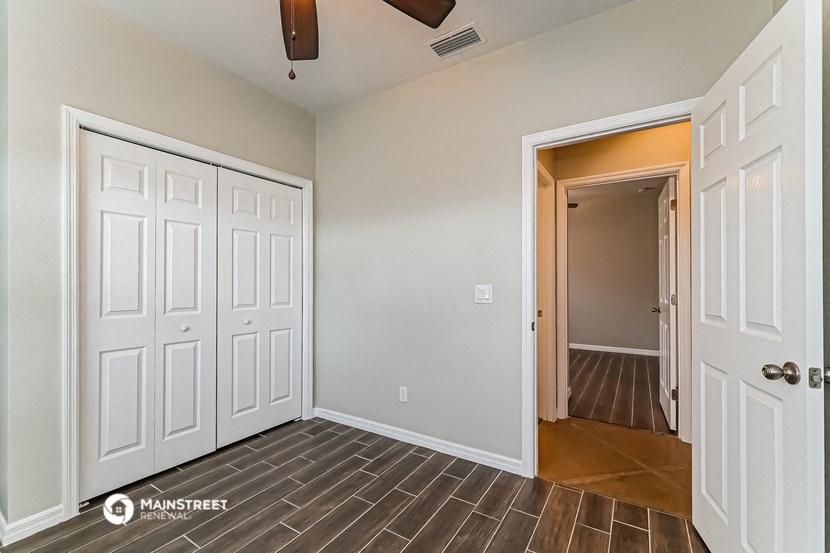 a bedroom with two closets and a door to a hallway