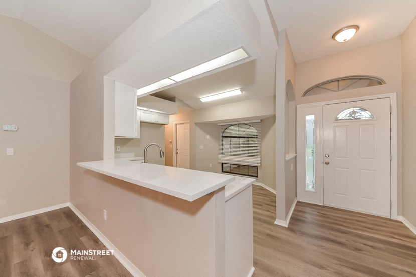 the kitchen is open to the dining room and living room