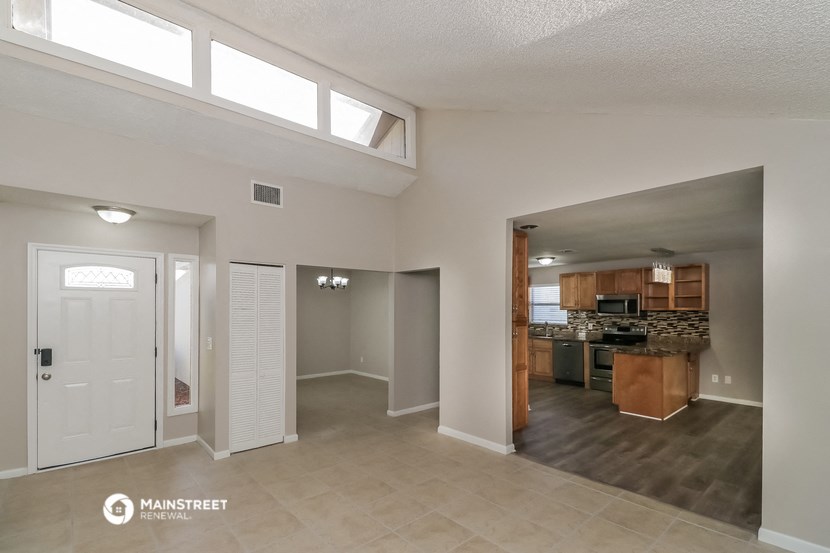 an open living room and kitchen with a white door