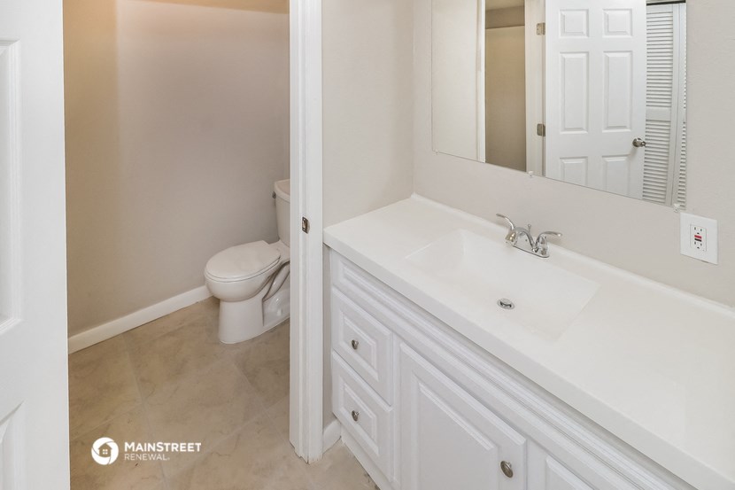 a bathroom with a sink and a toilet and a mirror