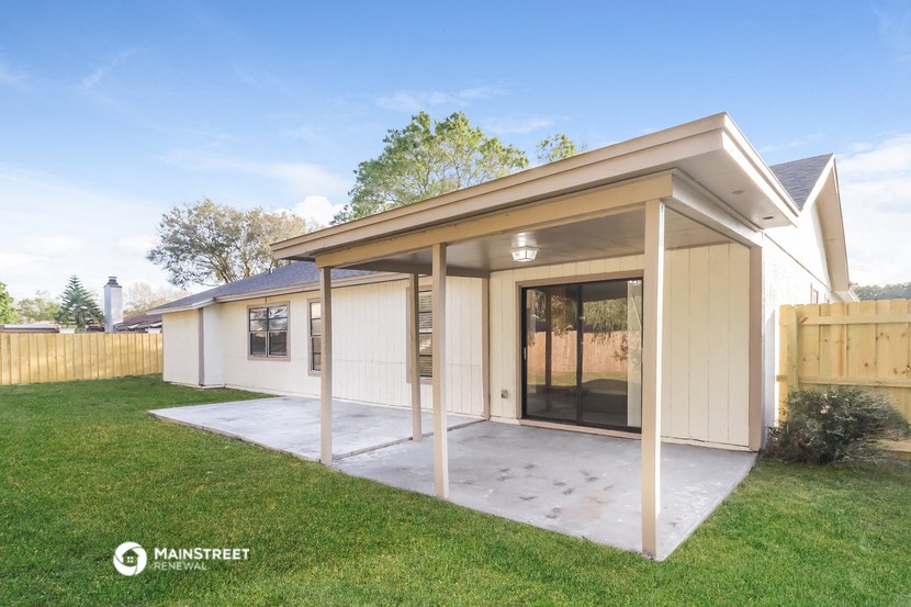 a covered patio in front of a house