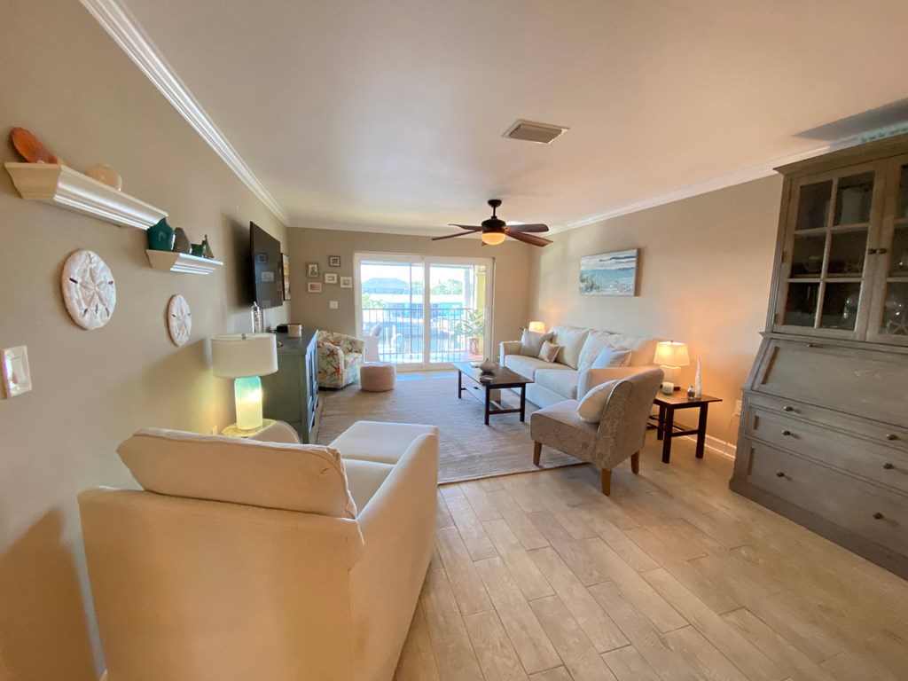 a living room with couches and chairs and a tv