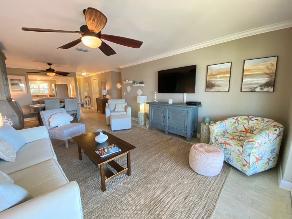 the living room has plenty of furniture and a flat screen tv