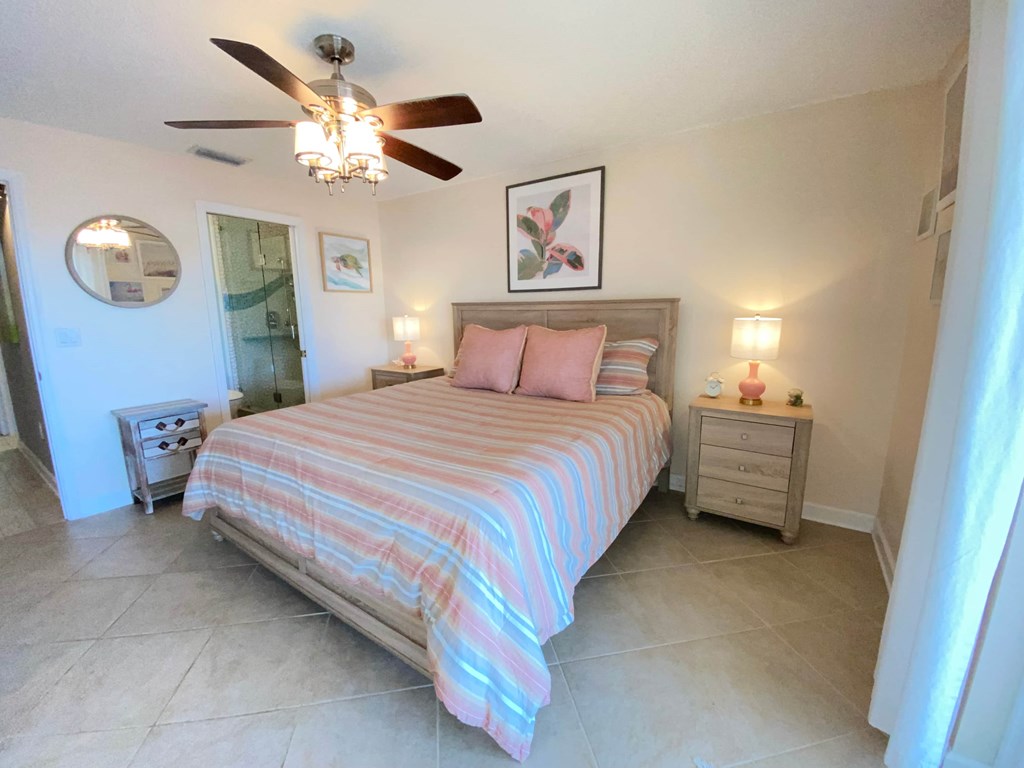a bedroom with a bed and a ceiling fan