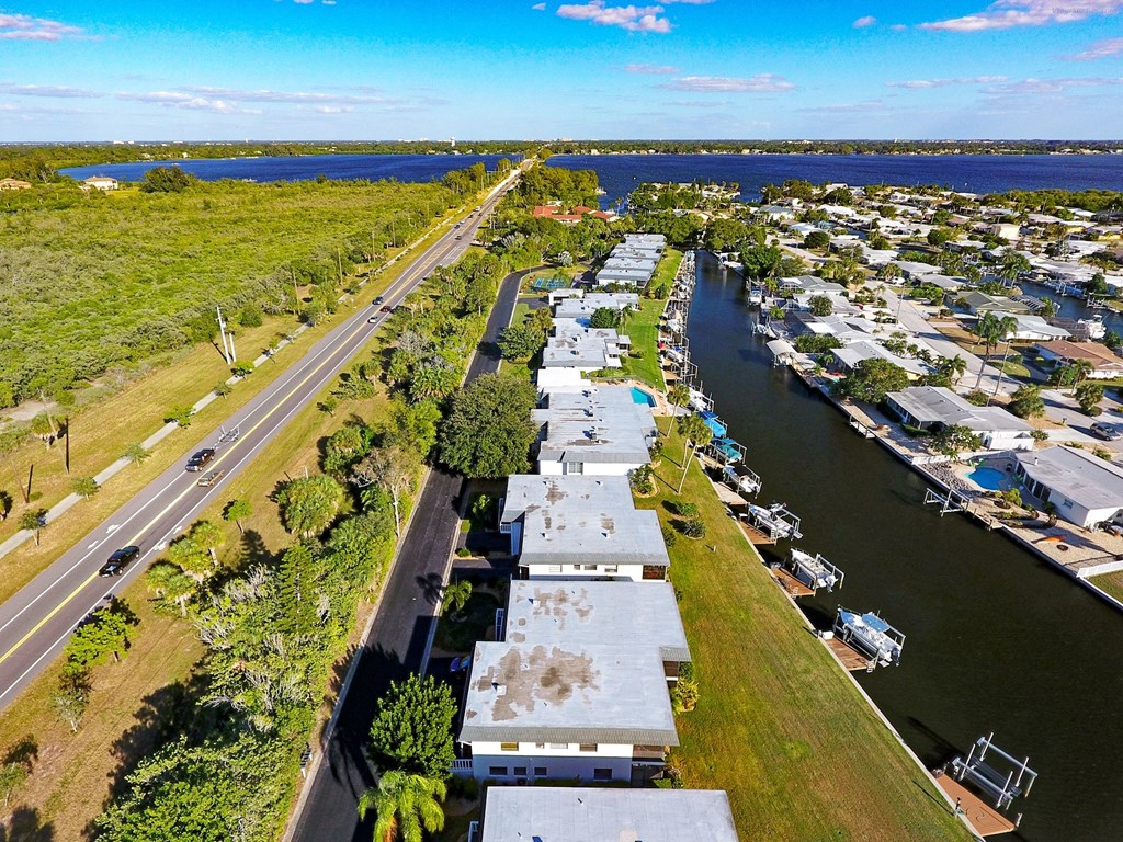 an aerial view of a marina with a highway and a river