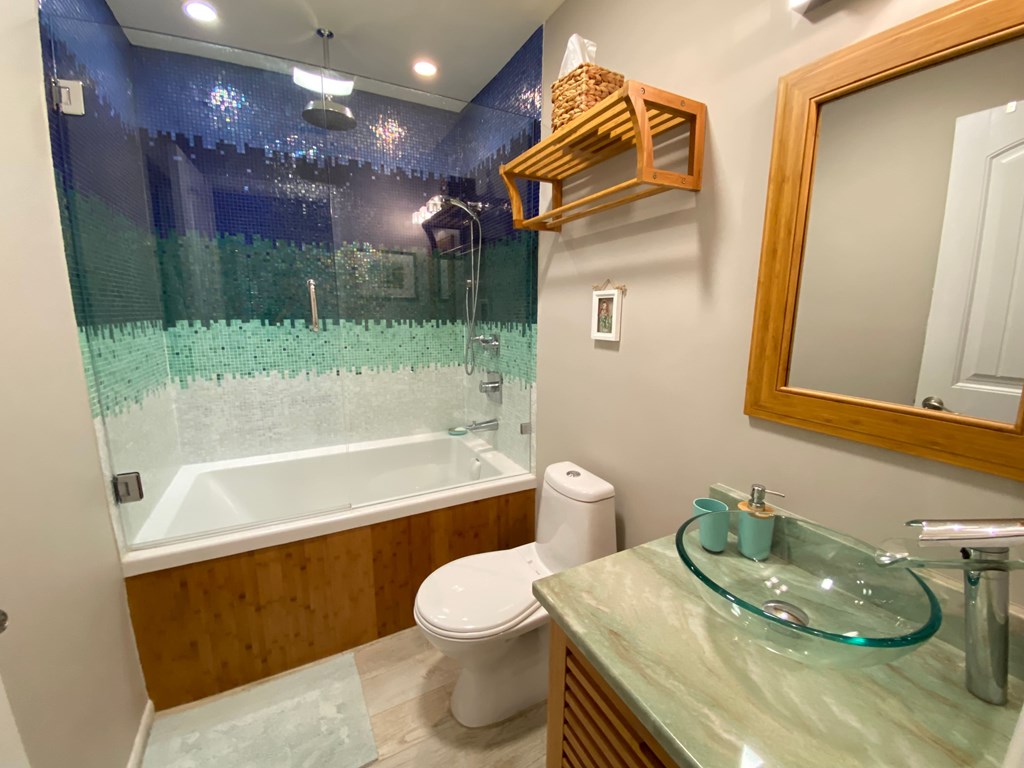 a bathroom with a sink toilet and a tub