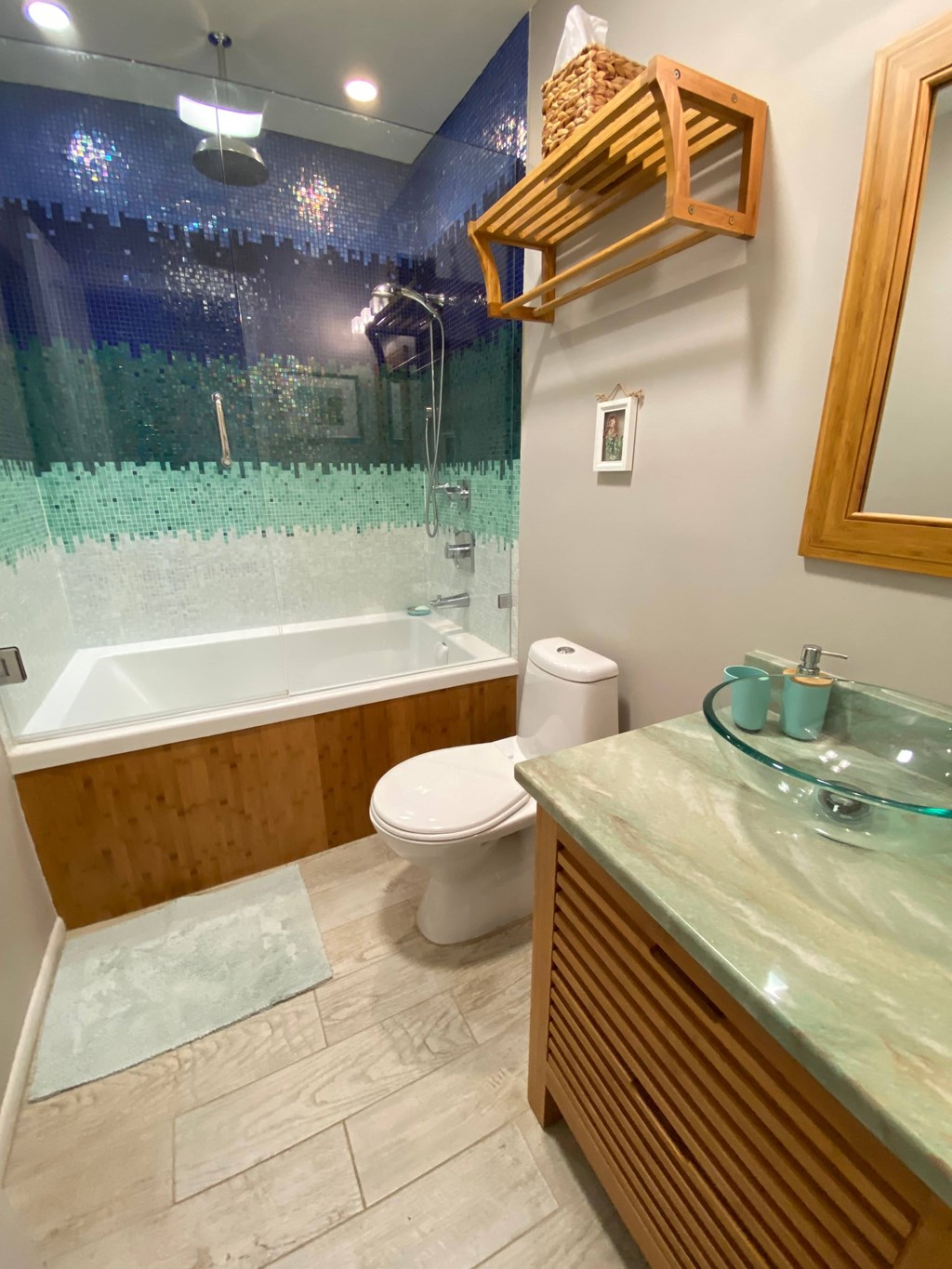 a bathroom with a toilet and a tub and a sink