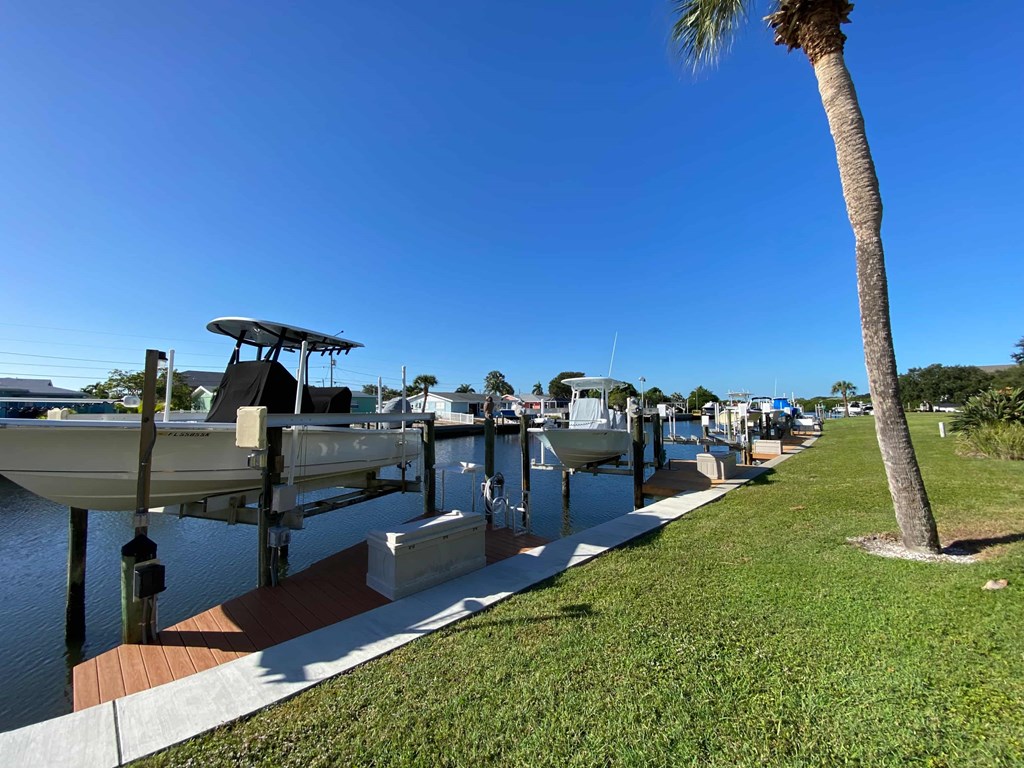a row of boats docked on the water at a marina