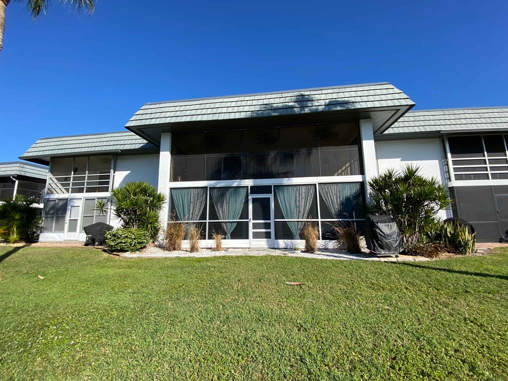 a white house with a lawn in front of it