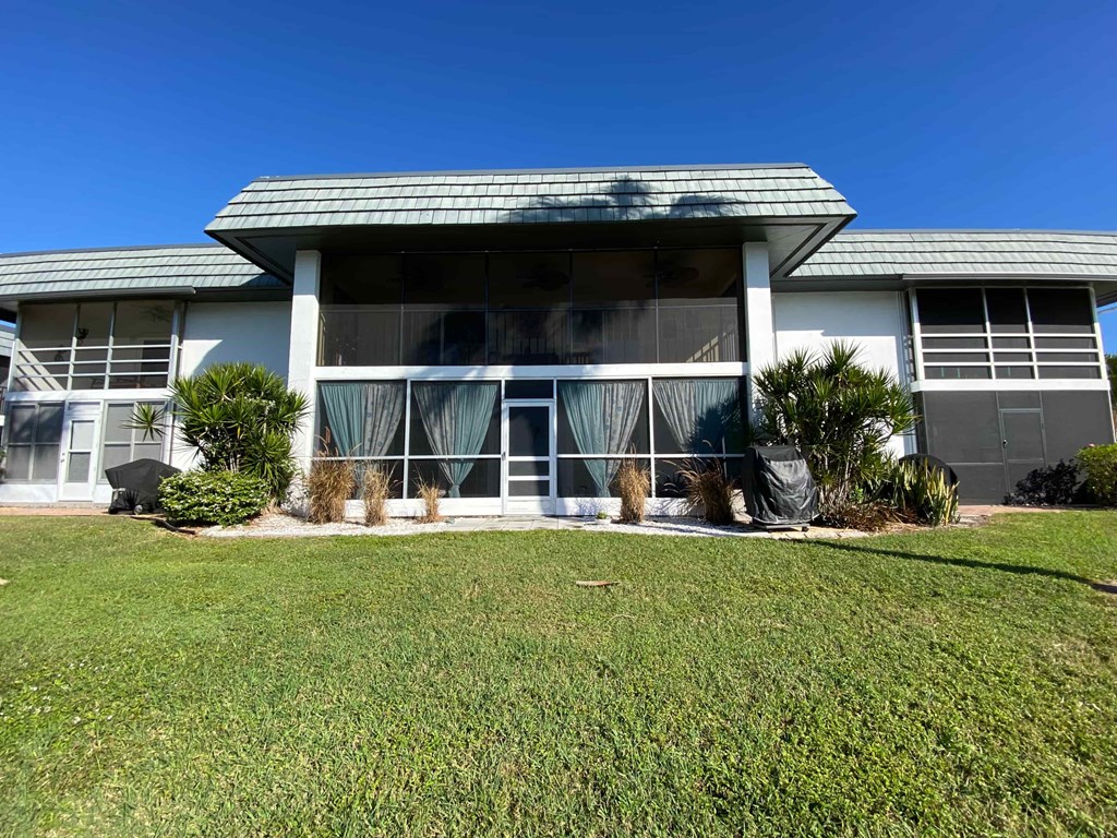 a white house with a lawn in front of it