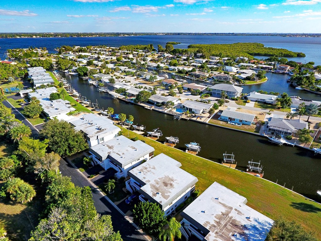 an aerial view of a marina with boats and houses on the water